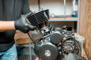 man-repairing-motorcycle-engine